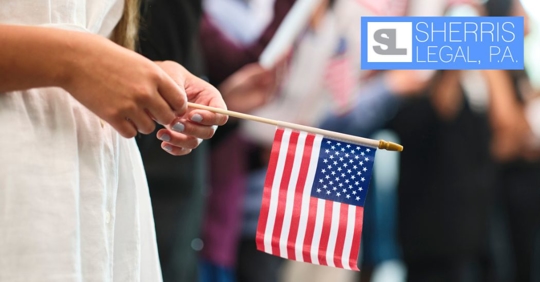 woman holding a small US flag