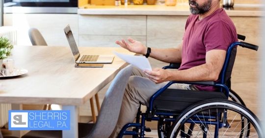 man on wheelchair using the laptop