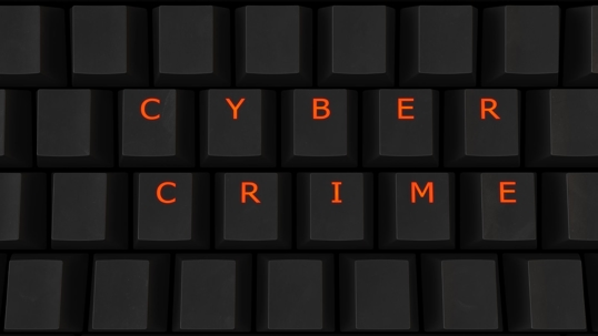 a keyboard that highlights words'cyber crime'