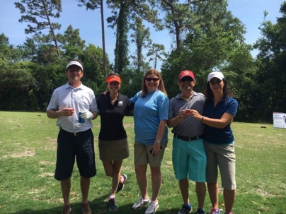 Mary Sherris, Jimmy Sherris, Phil Stiles, and Tom Vaughn at the golfing tournament.